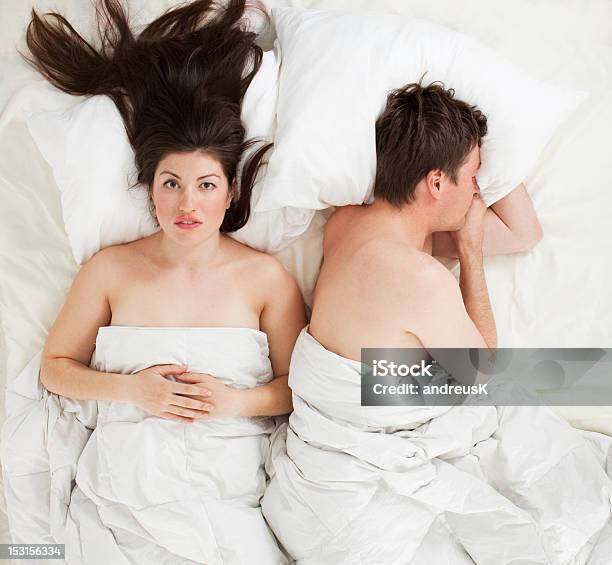 Man And Woman In Bed Not Getting Along Stock Photo - Download Image Now - Adult, Adults Only, Bed - Furniture
