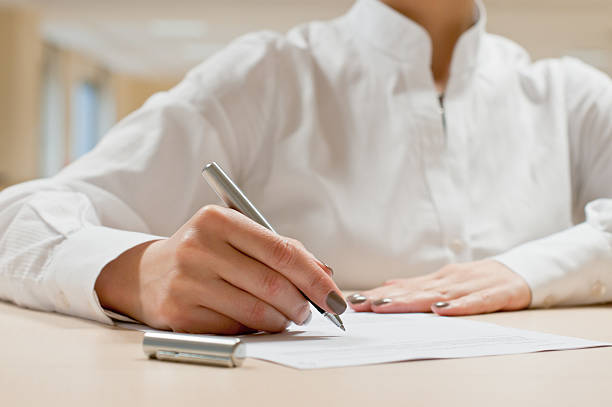 istock Business Woman is Writing on Paper 153156359