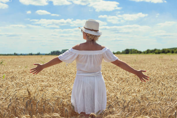 Free Stock Photo of Woman in White Dress and Hat Walking Through a ...