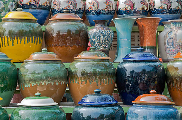 Traditional Thai Pottery on the Market Native Thai pottery lined up for sale at an outdoor market in Ratchaburi province, Thailand. ratchaburi province stock pictures, royalty-free photos & images