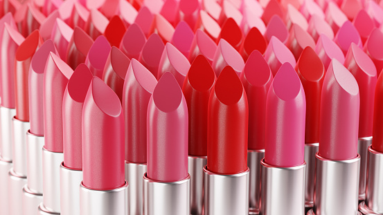 Collection of lipsticks in different tones of red. Beauty product, cosmetics, makeup.