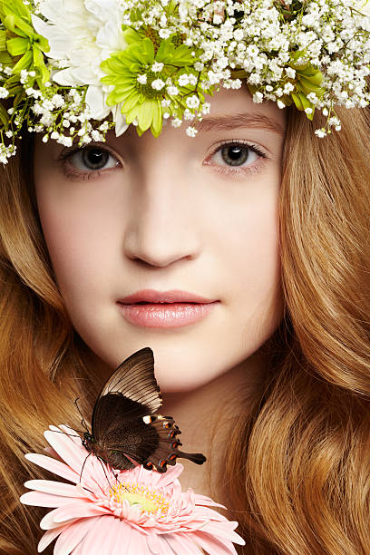 beautiful girl and butterfly closeup portrait of beautiful healthy redhead teen girl with butterfly on gerbera flower papilio palinurus stock pictures, royalty-free photos & images