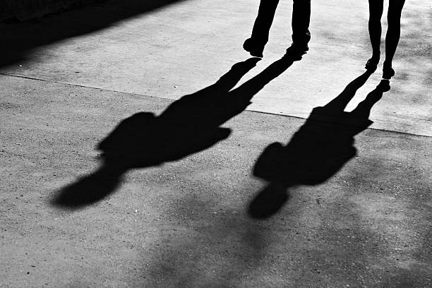 istock Shadows of two people on the sidewalk 153158098