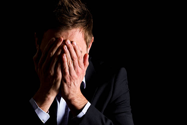 istock Desperate businessman covering his face 153158498