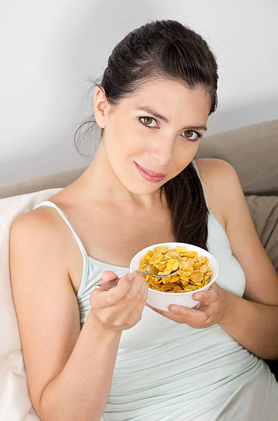 istock Young Woman Eating Cereal Flakes 153158640