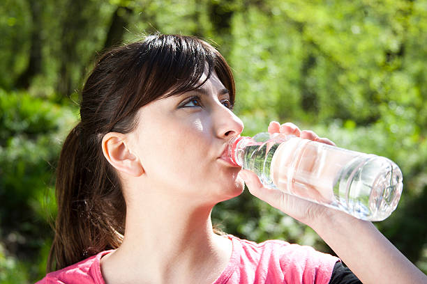 istock woman drinking water in nature 153159151