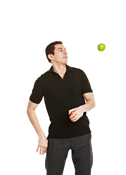 istock Handsome young man juggling apples 153160384