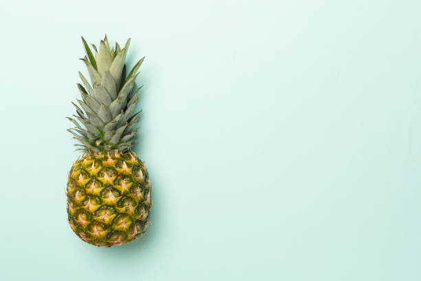 istock Fresh pineapple on color background, top view 1531619417
