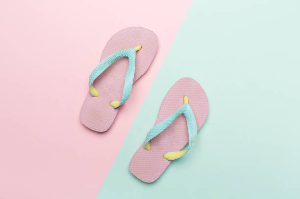 istock Bright flip flops on color background, top view 1531619425