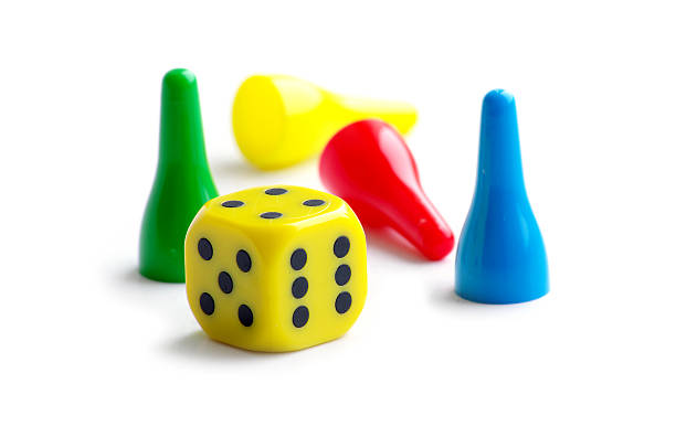 istock pawns in green, yellow, red and blue with a cube 153162094