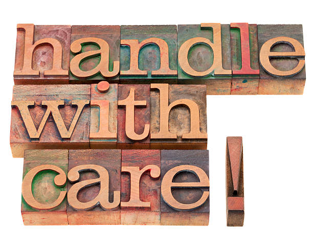 istock The words handle with care in wooden blocks 153162344