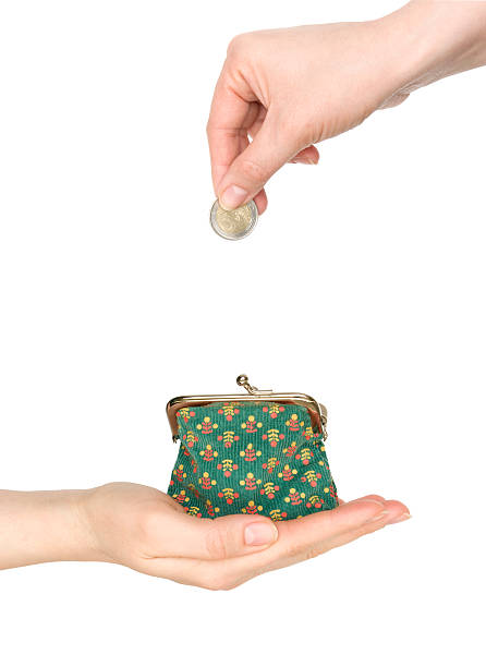 istock hand with a purse and coins in the other 153162355