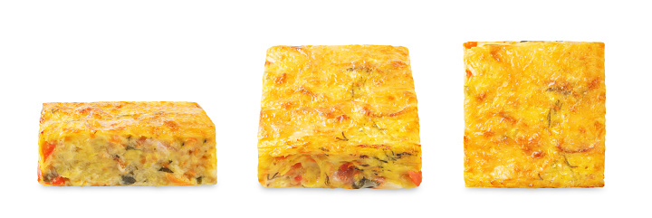 Zucchini carrot cheese bacon casserole slices on a white isolated background. toning
