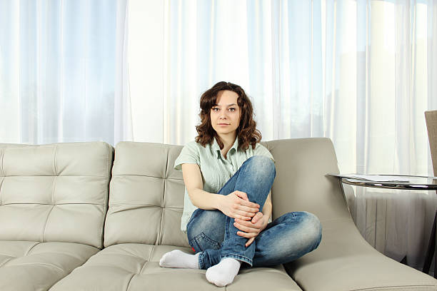 istock Young Woman on a couch 153162960
