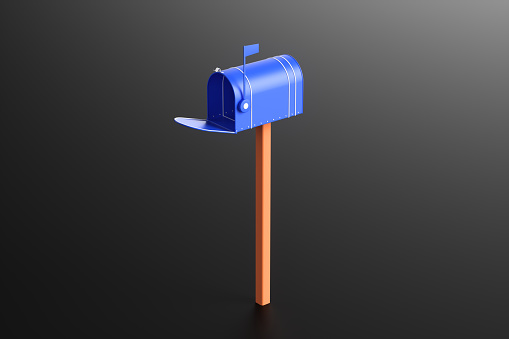 Mailbox with flag up against blue sky.