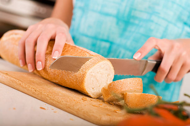 istock Woman cutting bread on the kitchen 153163406