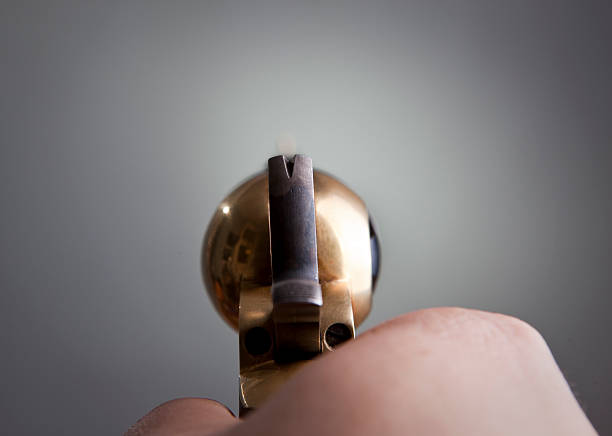istock View of an old revolver being pointed by a hand 153163469