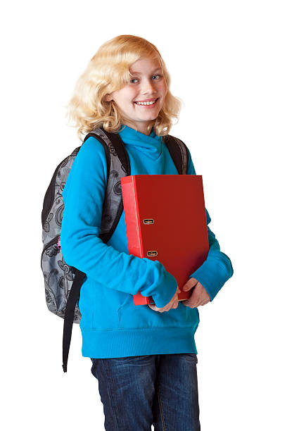 Young, pretty, blonde schoolgirl with schoolbag and folder smiles happy stock photo