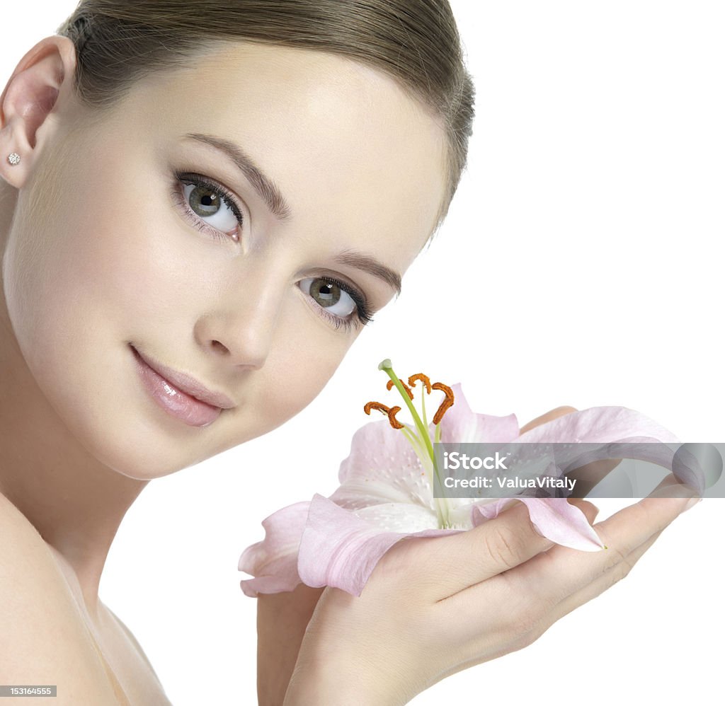 Pretty face of woman with lily Pretty face of beautiful young woman with lily on hands - white background Adult Stock Photo