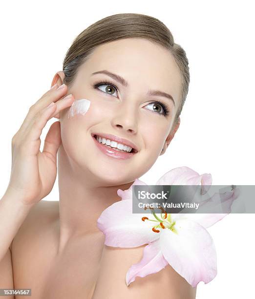 Happy Teen With Flower Applying Cream Stock Photo - Download Image Now - Adult, Adults Only, Applying