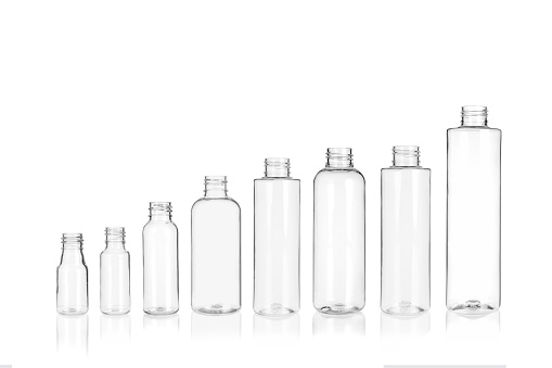 Transparent cylindrical small PET bottle container on white background. Template of a bottle for cosmetics and medical products.