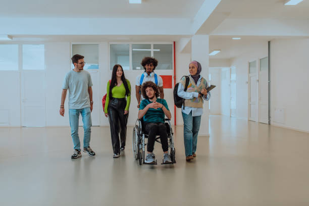 istock In a modern university, a diverse group of students, including an Afro-American student and a hijab-wearing woman, walk together in the hallway, accompanied by their wheelchair-bound colleague, symbolizing inclusivity, unity, and the power of education. 1531651412