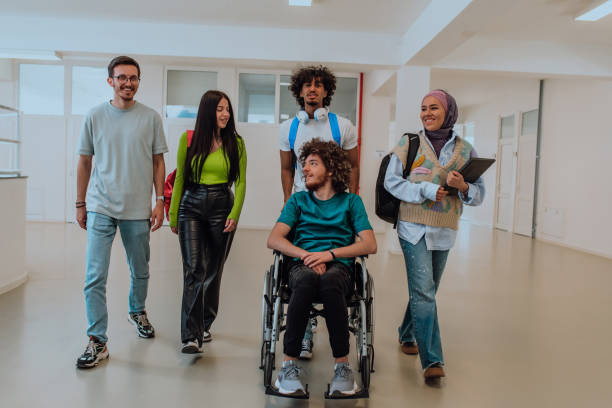istock In a modern university, a diverse group of students, including an Afro-American student and a hijab-wearing woman, walk together in the hallway, accompanied by their wheelchair-bound colleague, symbolizing inclusivity, unity, and the power of education. 1531651438