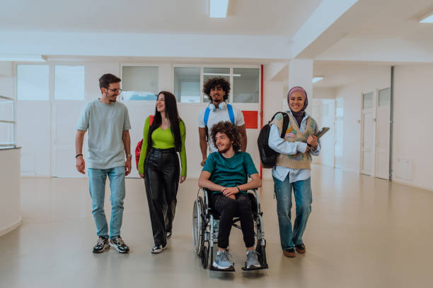 istock In a modern university, a diverse group of students, including an Afro-American student and a hijab-wearing woman, walk together in the hallway, accompanied by their wheelchair-bound colleague, symbolizing inclusivity, unity, and the power of education. 1531651513