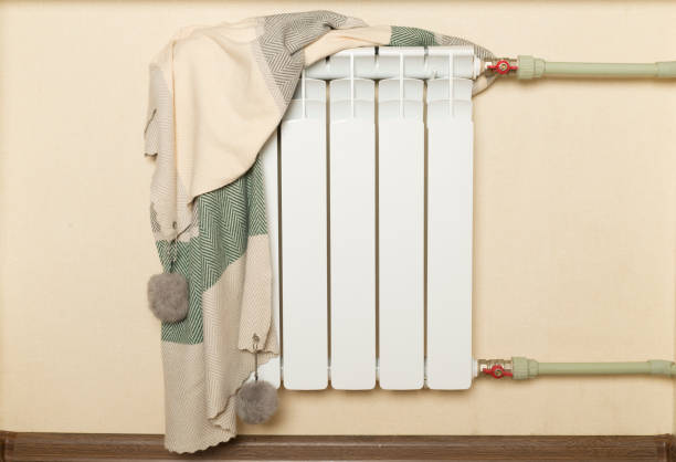 istock Bimetallic radiator with hat indoors. Winter heating concept 1531652066