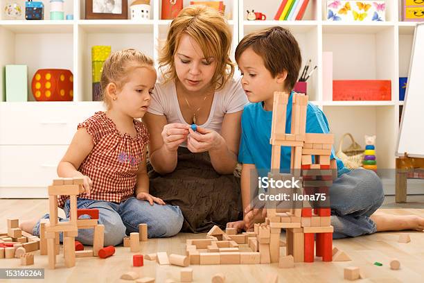 Family Activities In The Kids Room Stock Photo - Download Image Now - Activity, Adult, Beautiful People