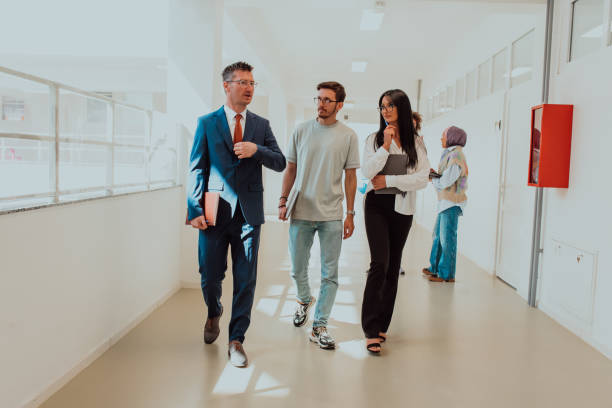 istock The director conducts a conversation with the secretary and a young programmer in a modern and spacious corridor of a large company, discussing various business topics and projects. 1531653731