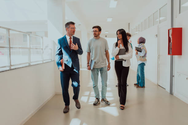 istock The director conducts a conversation with the secretary and a young programmer in a modern and spacious corridor of a large company, discussing various business topics and projects. 1531654770