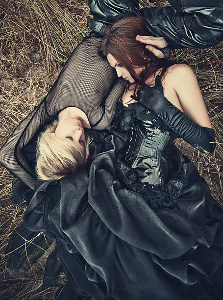 Young goth couple outdoors. Camera top view.