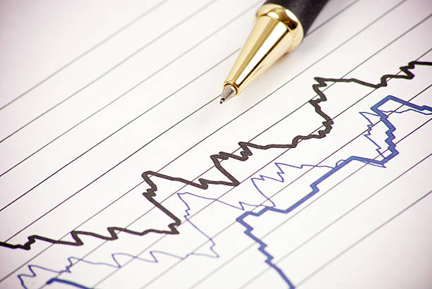 Seismology Graph Seismology graph with black and blue lines and a pen pointing to the graph seismology stock pictures, royalty-free photos & images