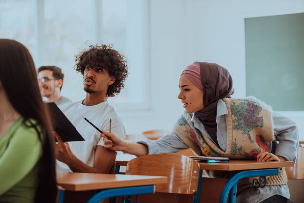 istock A group of diverse students engages in lively discussion as they educate themselves in a modern classroom, embracing the power of collaboration and knowledge exchange. 1531666850