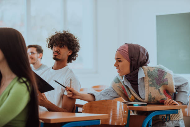 istock A group of diverse students engages in lively discussion as they educate themselves in a modern classroom, embracing the power of collaboration and knowledge exchange. 1531668421