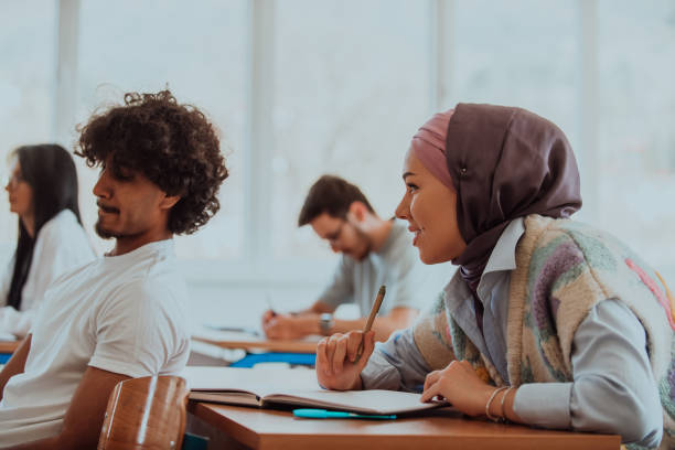 istock A group of diverse students engages in lively discussion as they educate themselves in a modern classroom, embracing the power of collaboration and knowledge exchange. 1531670558