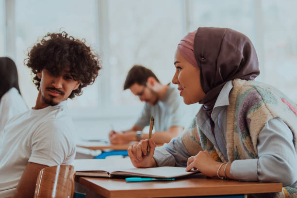 istock A group of diverse students engages in lively discussion as they educate themselves in a modern classroom, embracing the power of collaboration and knowledge exchange. 1531671644