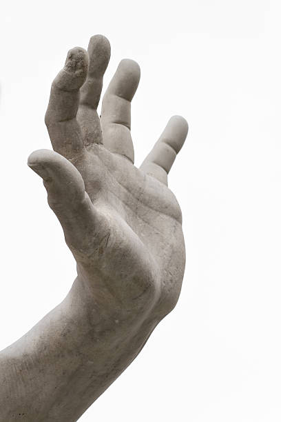 Hand holds a laurel wreath - bronze statue on golden background - Success and fame concept image with copy space.
