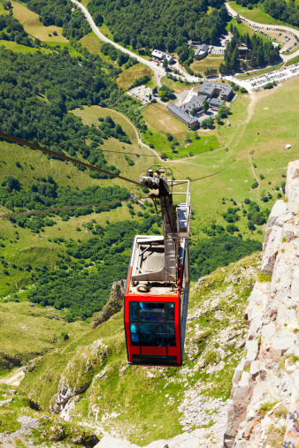 Top view of the clable car reaching the top of the mountain with the valley as background. In the heart of the Picos de Europa, the Fuente Dé Cable Railway overcomes a drop of 750 metres taking travellers to an altitude of 1,450 metres. Fuente Dé glacial circle, Cantabria, Spain. EOS 5D MarkII
