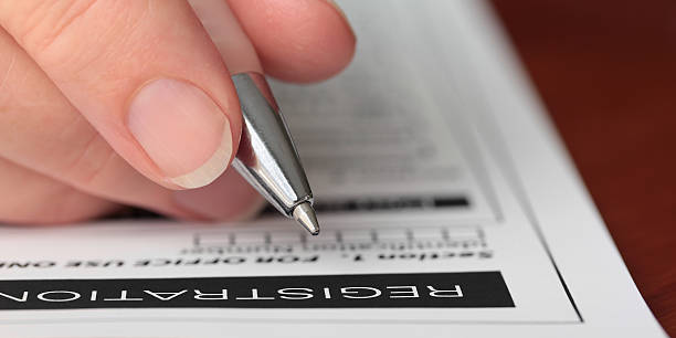 istock Hand with Pen Filling out a Form Closeup 153169518