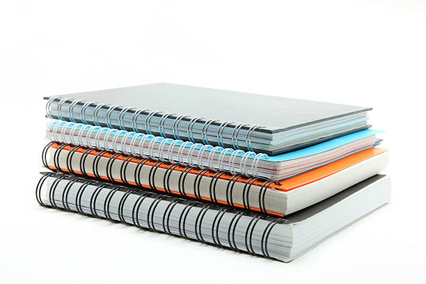 stack of ring binder hard cover book isolated on white stock photo