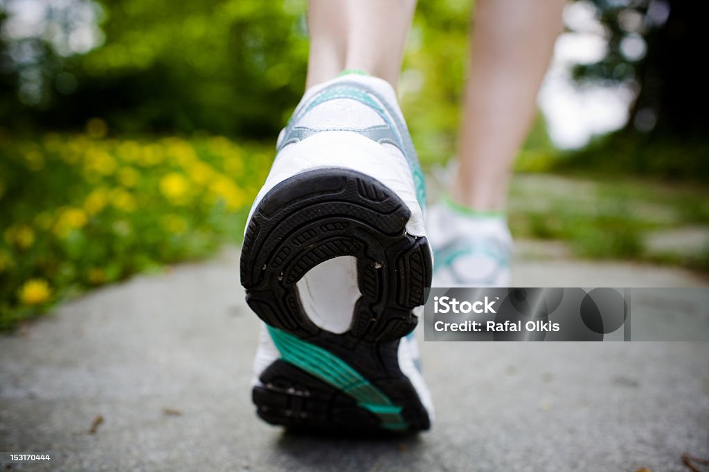 Donna che cammina nella foresta di primavera - Foto stock royalty-free di Abbigliamento sportivo