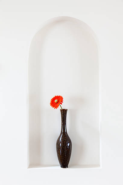 Vase with red flower Vase with a single red flower on a wall alcove alcove stock pictures, royalty-free photos & images