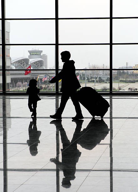 istock Children silhouette with big window airport background 153171095