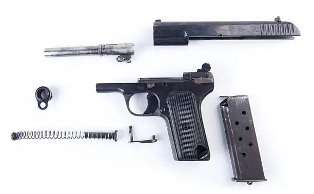 Russian pistol field stripped, isolated on a white background