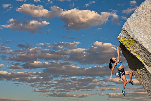istock Female rock climber holding on to rock with one hand 153171726