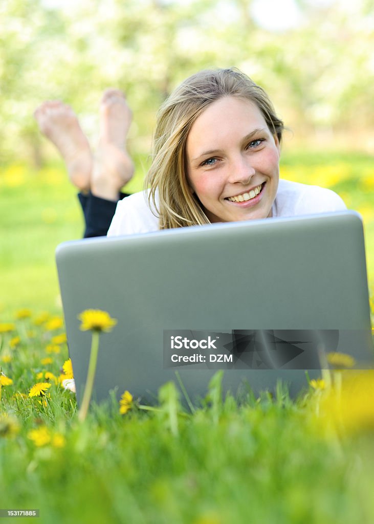 Girl with notebook Young girl using computer outdoor Adult Stock Photo