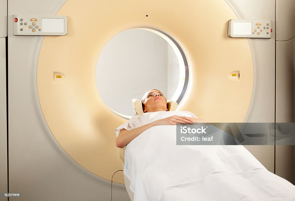 CT Scan A woman having a CT Scan taken Adult Stock Photo