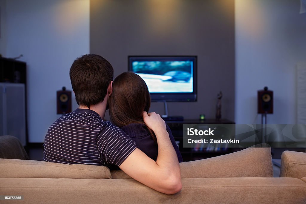 waching  movie Young couple waching  movie on tv Living Room Stock Photo